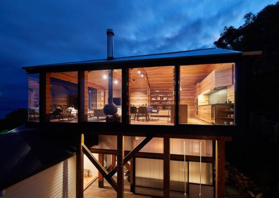 a house with a glass wall and a deck