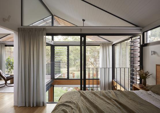 a bedroom with a balcony and a bed