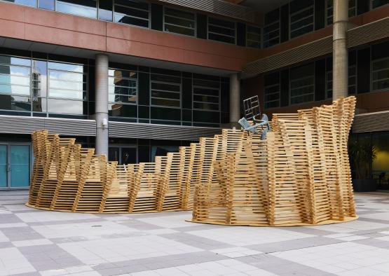 a group of wooden pieces in front of a building