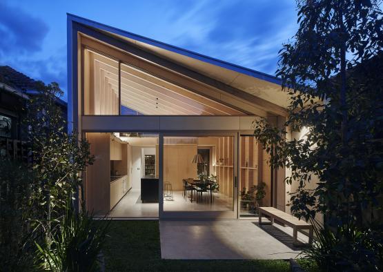 a house with a glass wall and a bench