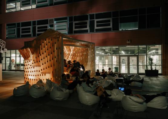 a group of people sitting in bean bags outside a building
