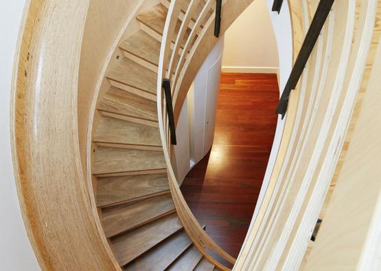 a spiral staircase with wood railings