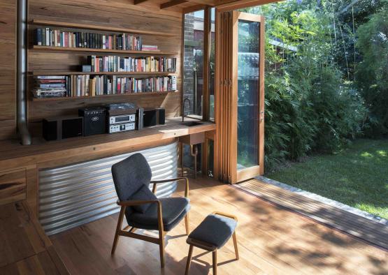 a room with a wood wall and a book shelf