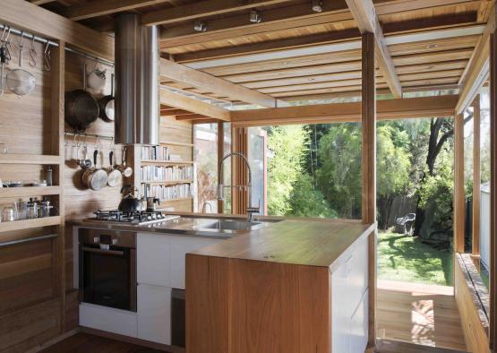 a kitchen with a wood ceiling and a wood wall