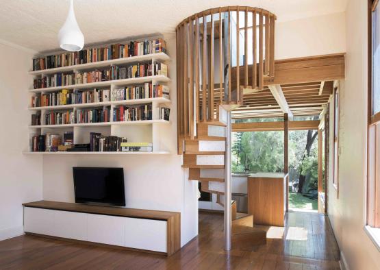 a spiral staircase in a room with bookshelves