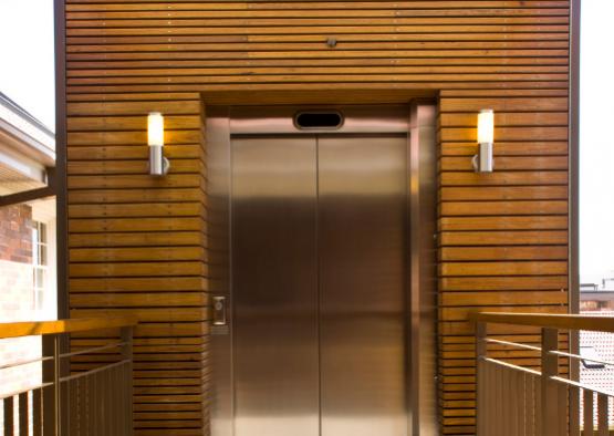 a metal elevator door with two lights
