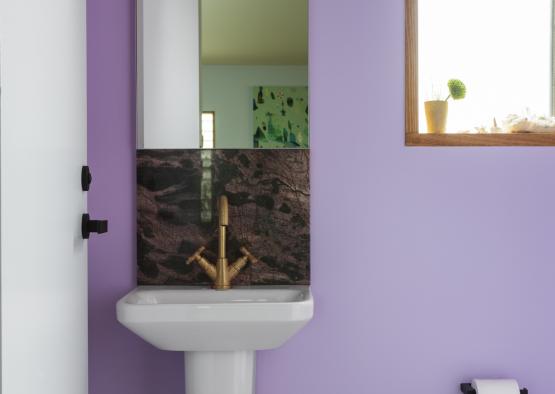 a sink in a purple bathroom