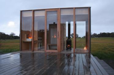 a glass building with a wood deck