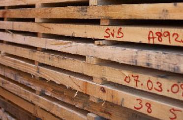 a stack of wooden pallets with red writing