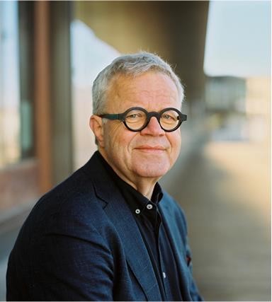 a man wearing glasses and a suit