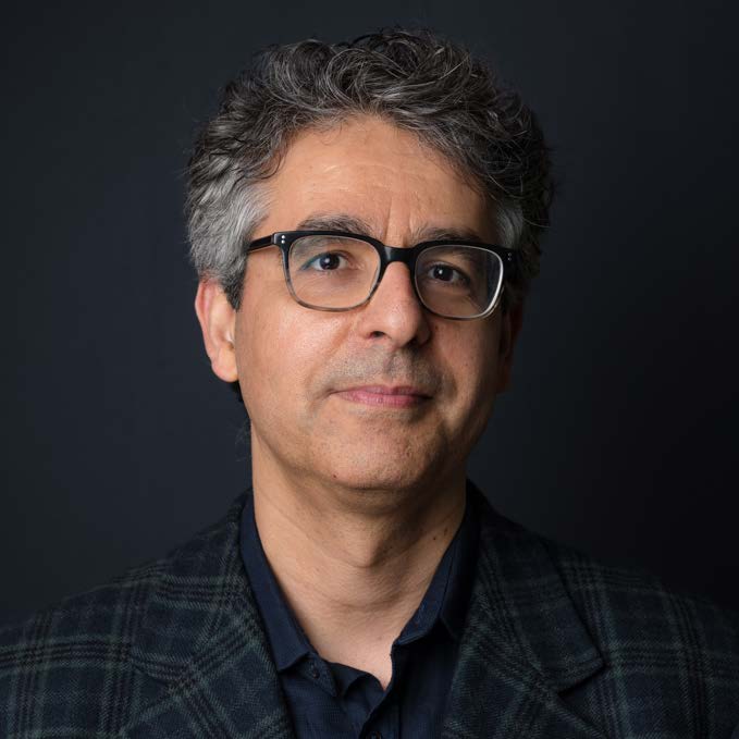 Professional headshot of man wearing glasses