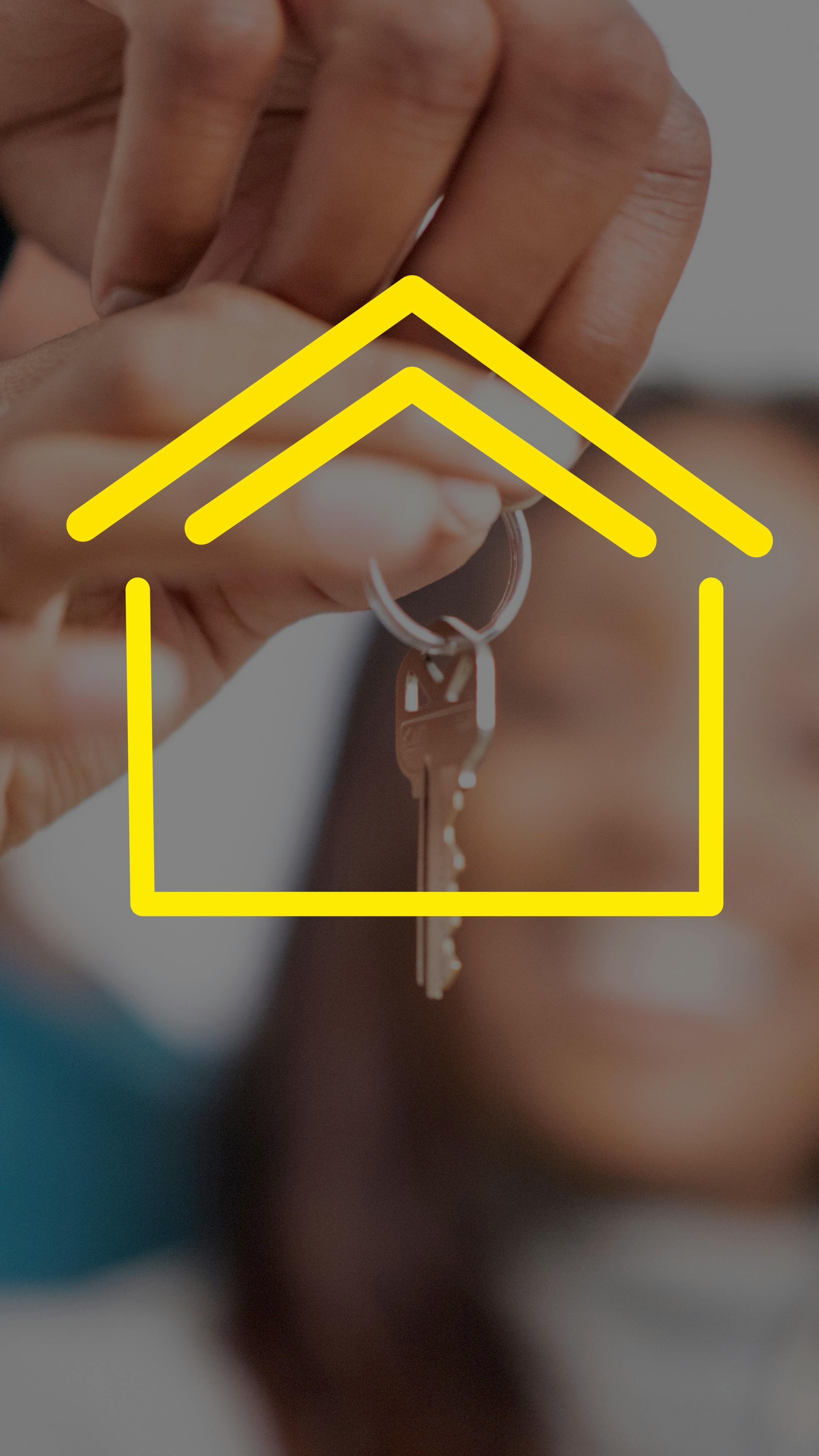 Person holding up a house key with a yellow house graphic overlay