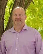 a man in a purple shirt