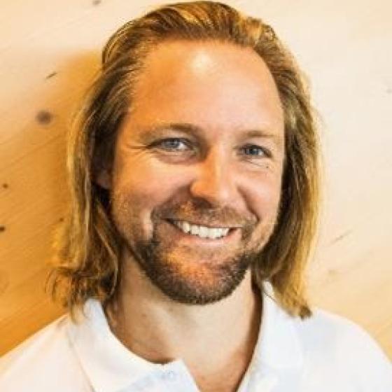 a man with long hair and beard smiling