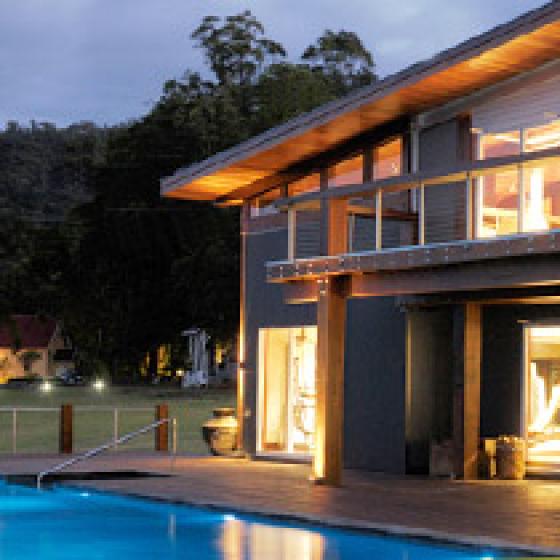 a house with a pool at night