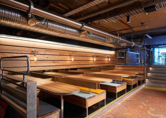 a room with wood benches and lights