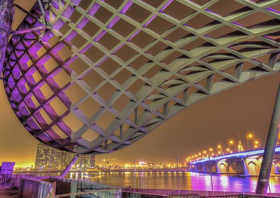 a bridge over water with a bridge in the background