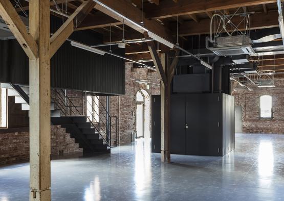 a room with a brick wall and stairs