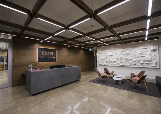 a reception desk and chairs in a building