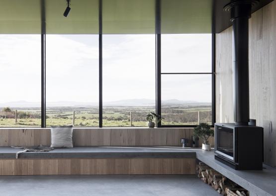 a room with a fireplace and a view of the landscape