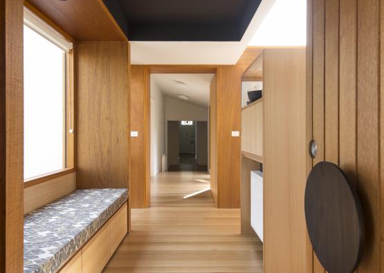 a hallway with a bench and a black ceiling