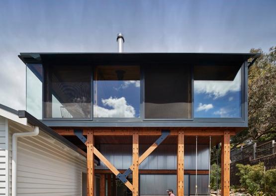 a house with a wooden structure and a table