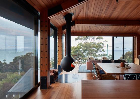 a room with a wood ceiling and a table and chairs