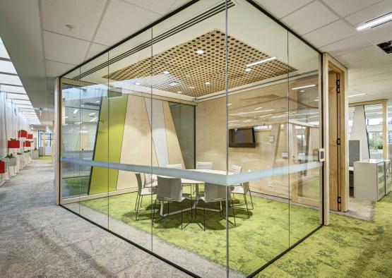 a glass wall with a table and chairs in it