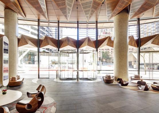 a lobby with a glass door and chairs