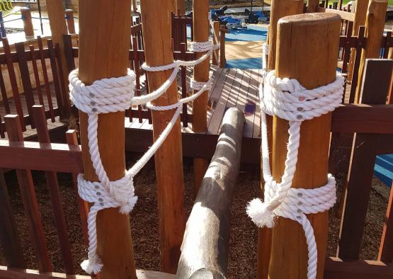 a wooden poles with white ropes tied around them