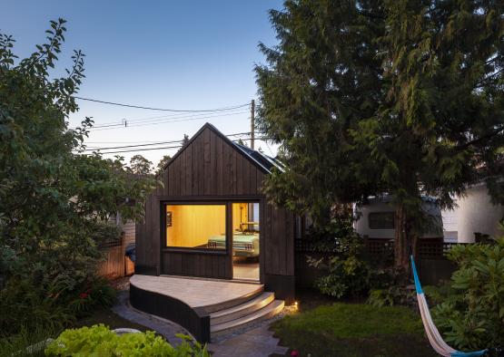 a small house with a porch and a hammock