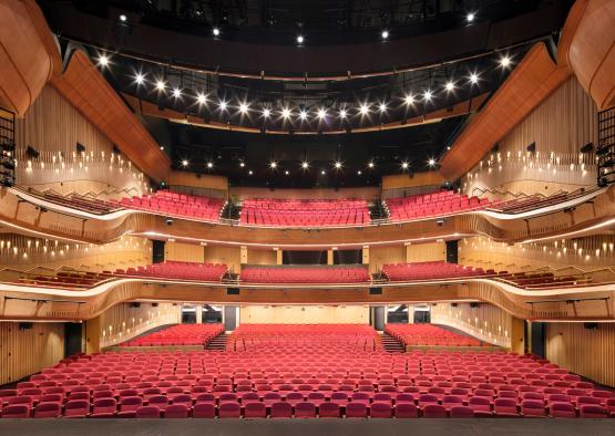 a large auditorium with red seats