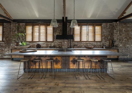 a kitchen with a large counter and stools