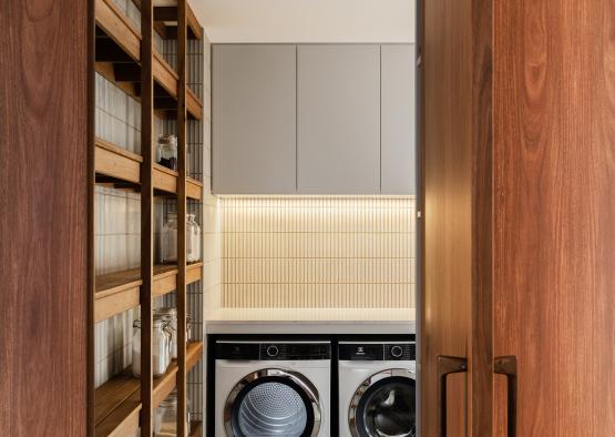 a laundry room with a dryer and shelves