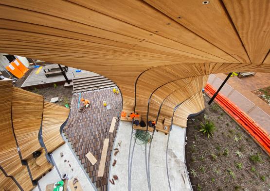 a wood structure with a group of people working on it