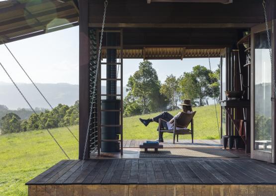 a person sitting in a chair on a porch