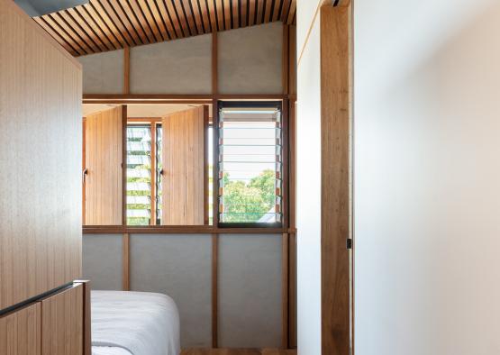 a room with wood ceiling and a bed