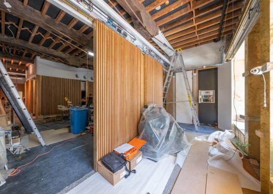 a room with a ladder and a wooden wall