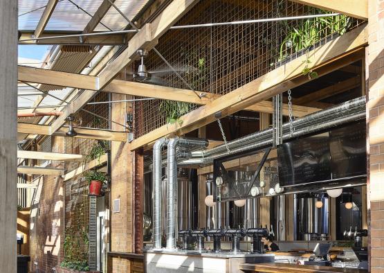 a room with a bar and a glass roof