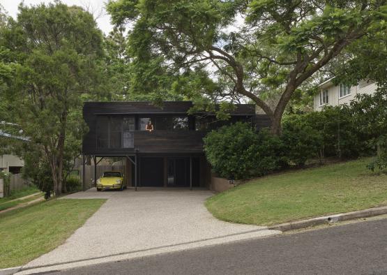 a house with a yellow car parked in front of it