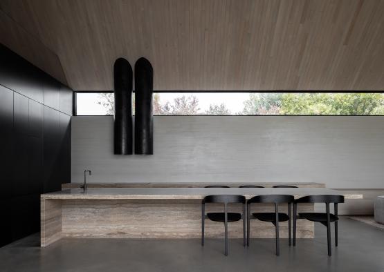 a kitchen with a counter and chairs