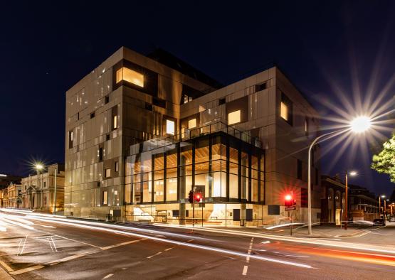 a building with lights on the side of the road