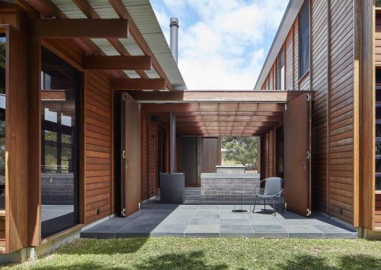 a patio with a chair and a brick fireplace