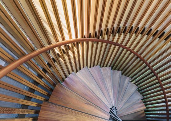 a spiral staircase with wood slats