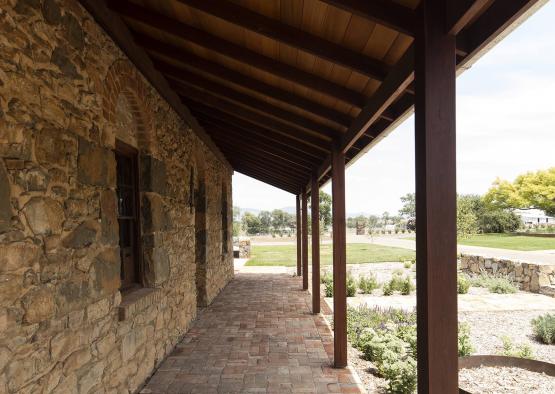 a stone building with a brick walkway