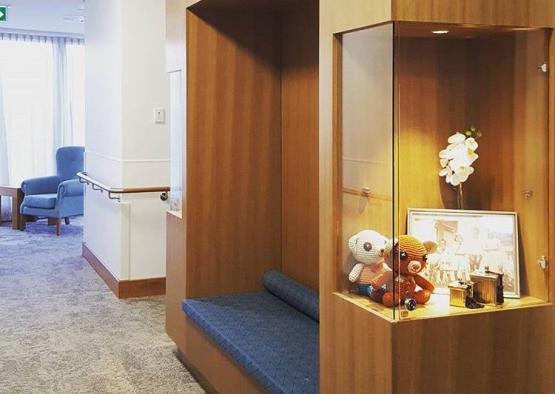 a room with a bench and a shelf with toys
