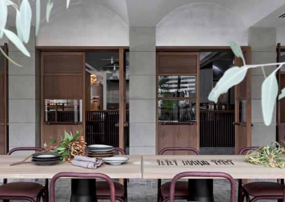 a table with plates and chairs in front of a building