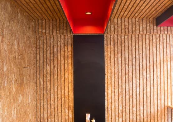 a black shelf with red ceiling and lights