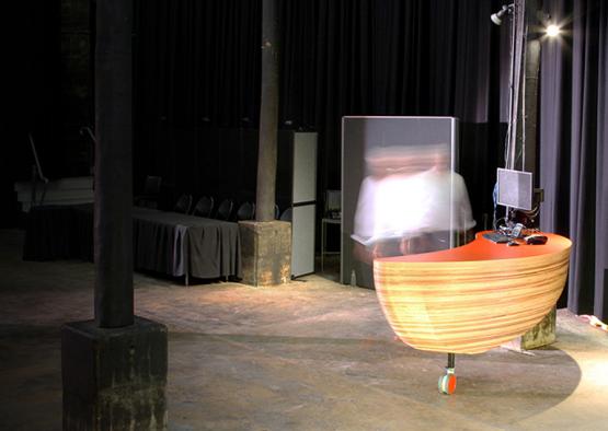 a wooden desk in a room with a person behind it