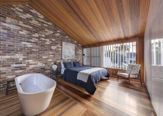 a bedroom with a tub and a bed